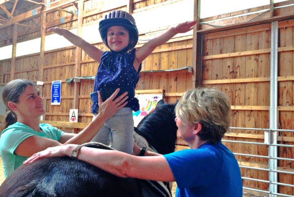 A child practices motor skills and challenges behavioral habits with the help of a horse in hippotherapy